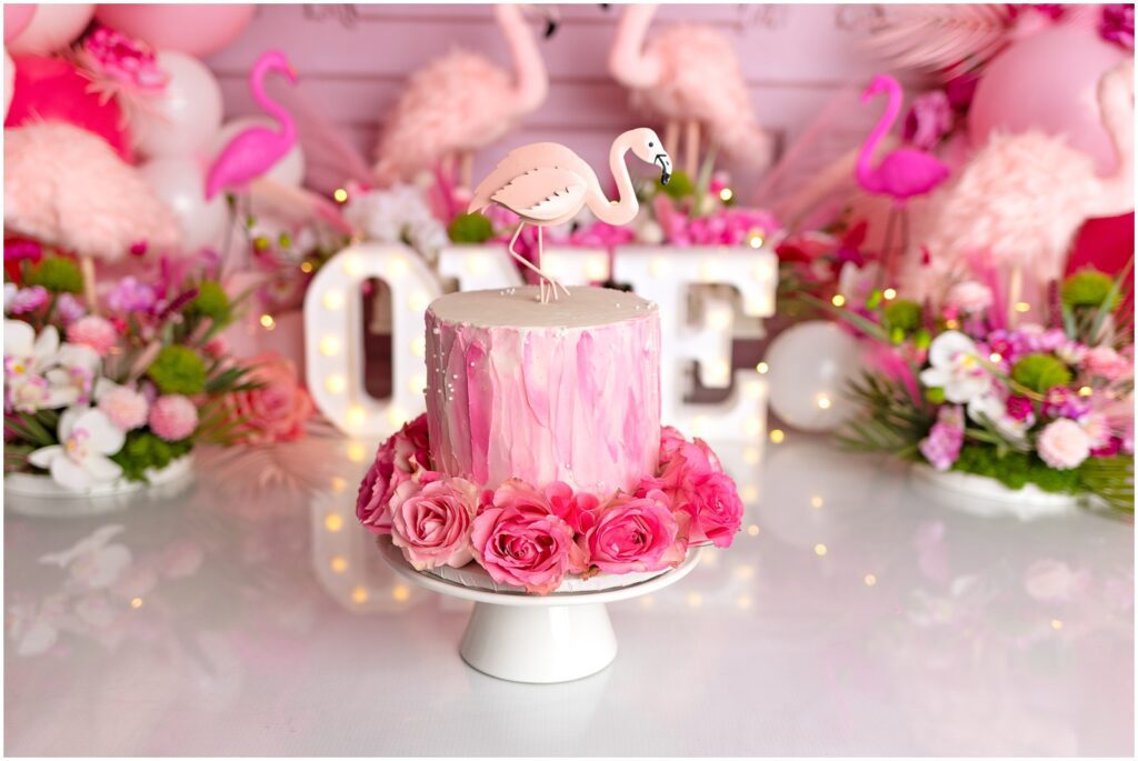 Flamingo Cake Smash First Birthday with pink decor and balloons. Photographed by Connecticut best Smash Cake Photographer. CT Cake Smash photographer. Westchester New York Cake Smash Photographer.